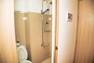 a bathroom with a shower and a toilet at 1bedroom with Balcony facing pool Near MOA in Manila