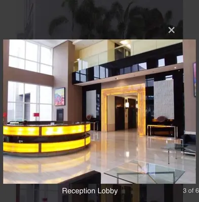 a lobby of a building with a yellow and black at A-South of Market SOMA in Manila