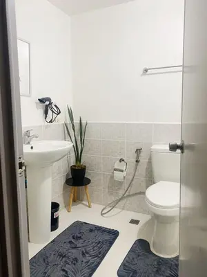 a bathroom with a toilet and a sink at A-South of Market SOMA in Manila