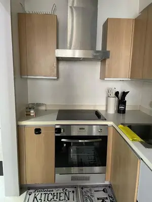 a kitchen with a stove top oven in a kitchen at A-South of Market SOMA in Manila