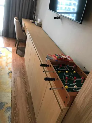 a wooden counter with a table with a billiardhibitionhibitionhibition at The Metro Zen at Hotel Residences Acqua - Novotel Tower in Manila