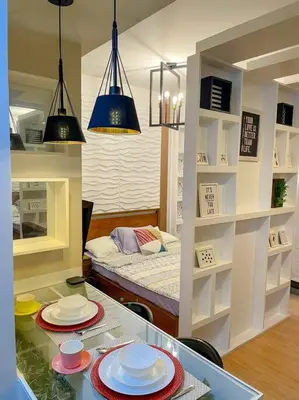 a room with a table with plates and a bed at Deryll's Fun house in Manila