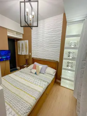 a bedroom with a large bed in a room at Deryll's Fun house in Manila