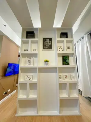 a white book shelf in a room at Deryll's Fun house in Manila