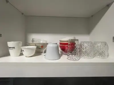a shelf with bowls and other items on it at Gentry Manor Balcony Green View WiFi Netflix Walk to Okada Casino 8J in Manila