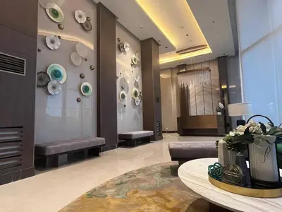 a lobby with benches and a table in a building at Gentry Manor Balcony Green View WiFi Netflix Walk to Okada Casino 8J in Manila