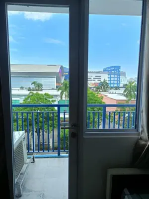 a door to a balcony with a view of a city at Alley condotel Sea Residence in Manila