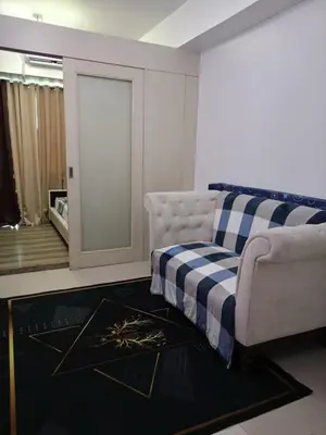 a living room with a couch and a window at Alley condotel Sea Residence in Manila