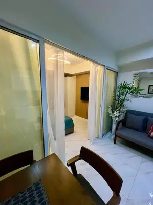 a living room with a table and a couch at Azure South Bicutan spacious 1BR BEST view in Manila