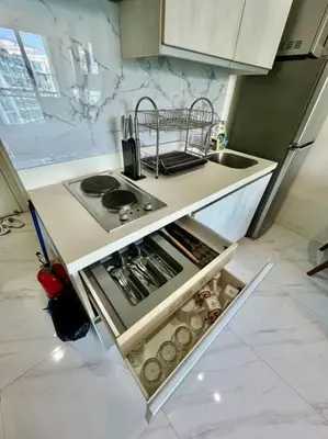 a small kitchen with a stove and a sink at Azure South Bicutan spacious 1BR BEST view in Manila