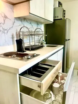 a kitchen with a sink and a stove top oven at Azure South Bicutan spacious 1BR BEST view in Manila