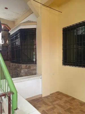 a room with two barred windows in a building at Casa Regine in Manila