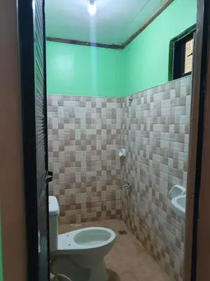 a bathroom with a toilet and a sink at Casa Regine in Manila