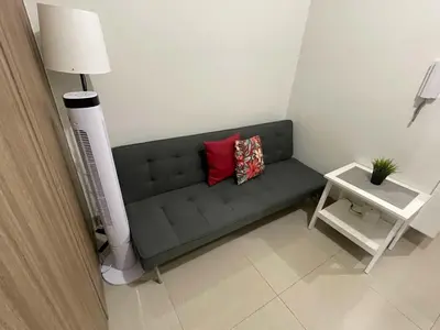 a couch with two pillows on it in a room at Tower 3 Shore 2 High Floor 1BR Good 4PAX in Manila