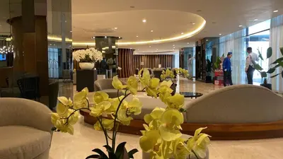 a lobby with couches and flowers in a building at Tower 3 Shore 2 High Floor 1BR Good 4PAX in Manila
