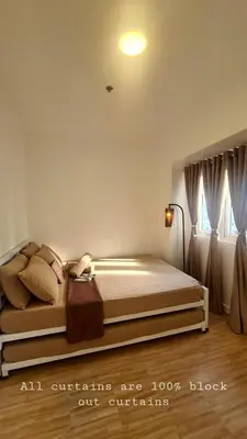 a bedroom with a bed in a room at Tahanan - Victoria de Makati in Manila
