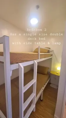 a bedroom with a bunk bed with a quote on the wall at Tahanan - Victoria de Makati in Manila
