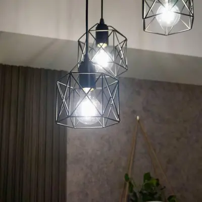 three lights hanging from the ceiling in a room at Gabila Staycation at Azure in Manila