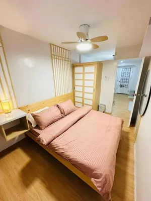 a bedroom with a large bed with pink sheets at Tiffany's Place in Imus