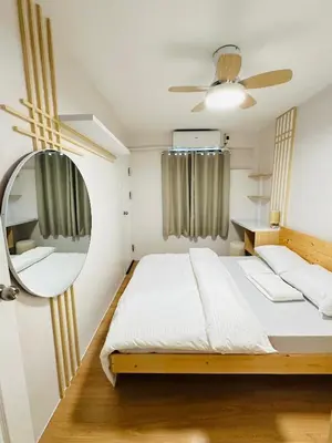 a bedroom with a bed and a mirror at Tiffany's Place in Imus