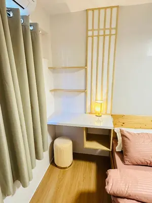 a room with a desk and a bed and a table at Tiffany's Place in Imus