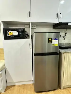 a kitchen with a refrigerator and a microwave at Tiffany's Place in Imus