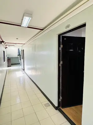 an empty hallway with a black door in a building at Tiffany's Place in Imus