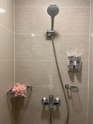 a shower with a shower head in a bathroom at Beautiful Studio Near Resorts World NAIA T3 in Manila