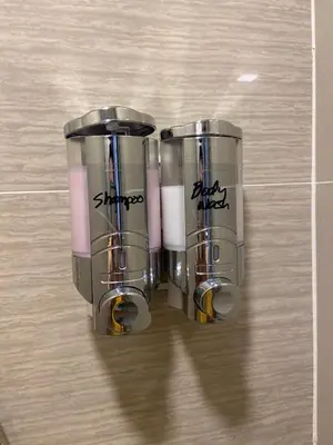 two silver cups sitting on top of a tile floor at Beautiful Studio Near Resorts World NAIA T3 in Manila