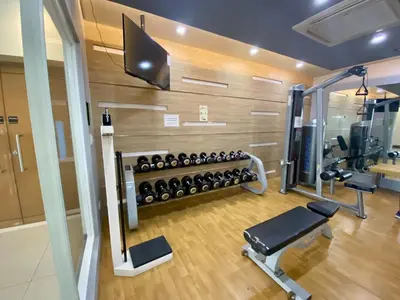 a fitness room with a gym with weights at Beautiful Studio Near Resorts World NAIA T3 in Manila