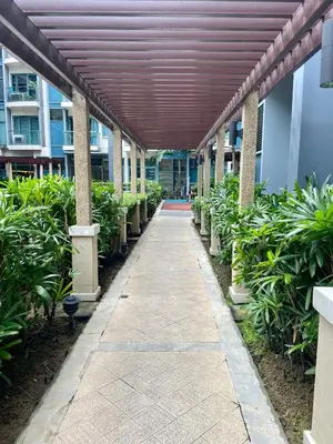 a hallway of a building with awning and plants at Beautiful Studio Near Resorts World NAIA T3 in Manila