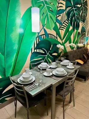 a dining room table with plates and glasses on it at Beautiful Studio Near Resorts World NAIA T3 in Manila
