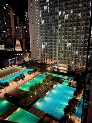 an overhead view of a pool in a city at night at P3K Jazz Staycation in Manila