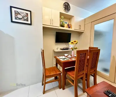 a small dining room with a table and chairs at P3K Jazz Staycation in Manila
