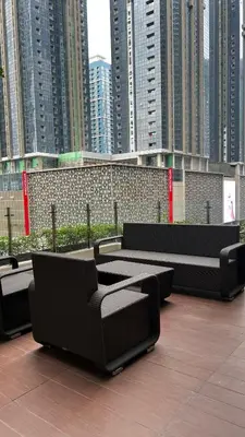 a row of benches on a rooftop with tall buildings at Affordable 1BR Staycation at One Uptown BGC in Manila