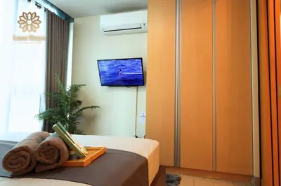 a hotel room with a bed with a tv on the wall at Affordable 1BR Staycation at One Uptown BGC in Manila