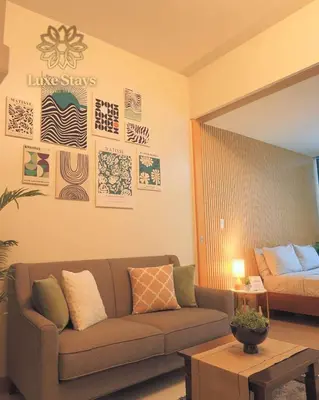 a living room with a couch and a bed at Affordable 1BR Staycation at One Uptown BGC in Manila