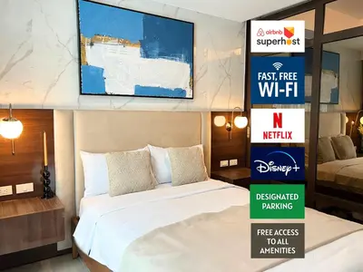 a hotel room with a bed and a sign that says first free wifi at Luxurious 1BR Staycation at One Uptown BGC in Manila