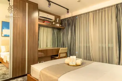 a hotel room with a bed and a desk at Luxurious 1BR Staycation at One Uptown BGC in Manila
