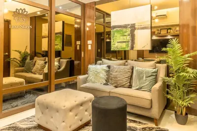 a lobby with a couch and a chair and a table at Luxurious 1BR Staycation at One Uptown BGC in Manila