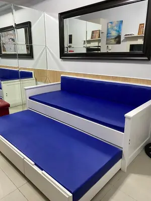 a blue bed in a room with a mirror at Great Stay in Manila in Manila
