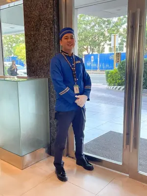 a man is standing in front of a glass door at Great Stay in Manila in Manila