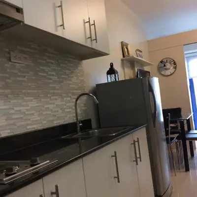 a kitchen with a sink and a refrigerator at Great Stay in Manila in Manila