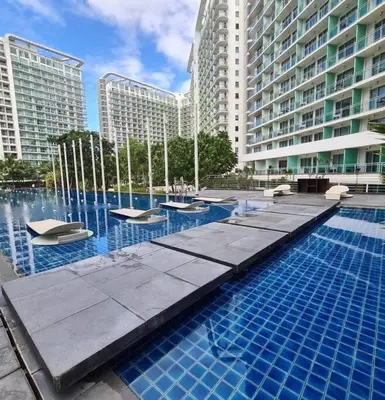 a swimming pool in a city with tall buildings at Dsa'sCrib 1BR Azure Near Airport in Manila