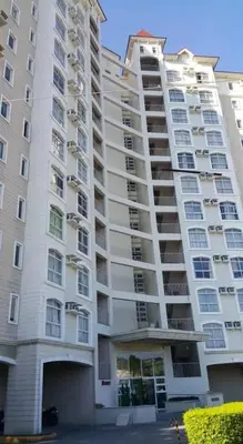 a large white apartment building with a lot of windows at Emjay's staycation in Manila