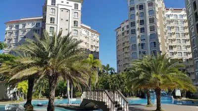 a group of palm trees and tall buildings at Emjay's staycation in Manila