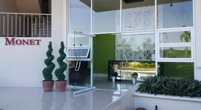 a lobby of a building with potted plants at Emjay's staycation in Manila