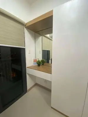 a kitchen with a counter and a large mirror at Lush Suite Makati in Manila