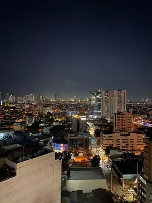 a view of a city at night with buildings at Lush Suite Makati in Manila