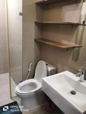 a bathroom with a white toilet and a sink at Nadzcondotel - at Two Palm Tree Villas o in Manila